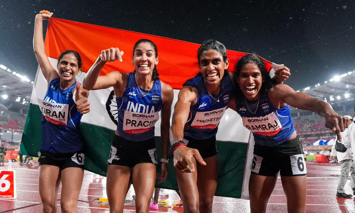 Indian women athletes celebrate with the national flag after winning medals at Asian Games 2026